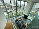 Modern living room with large windows and city view