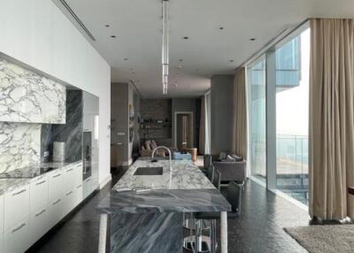Modern kitchen with marble countertop and floor-to-ceiling windows