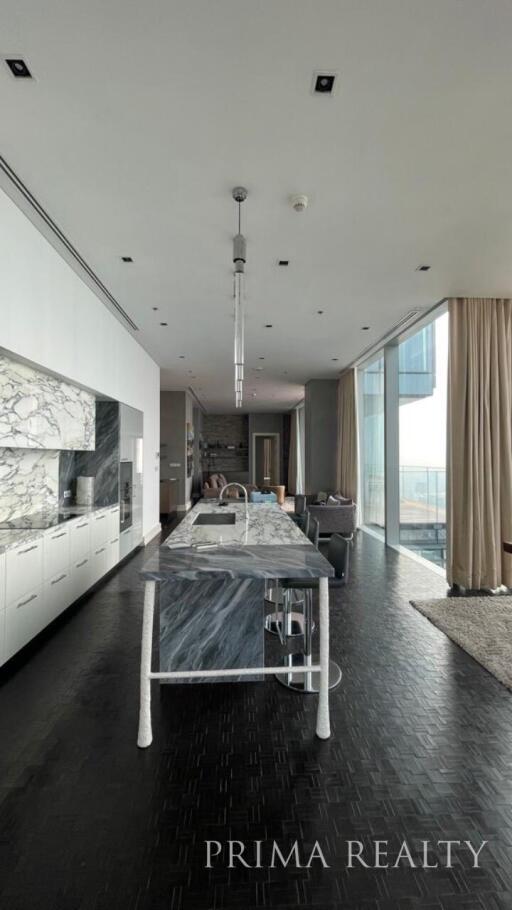 Modern kitchen with marble countertop and floor-to-ceiling windows