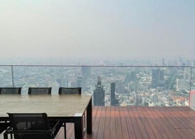 Spacious balcony with outdoor dining set and panoramic city view
