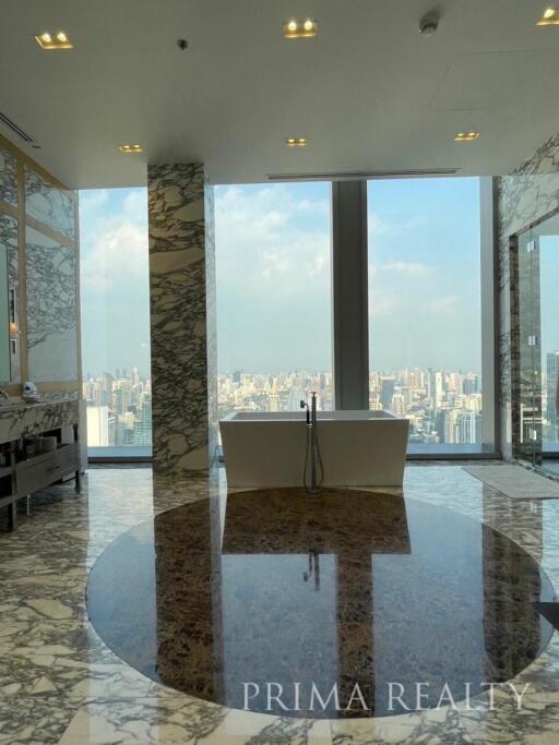Luxurious bathroom with freestanding tub and panoramic city view