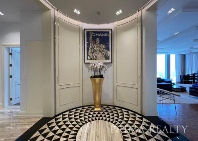 Elegant foyer with black and white floor design and chic wall art in a luxury home