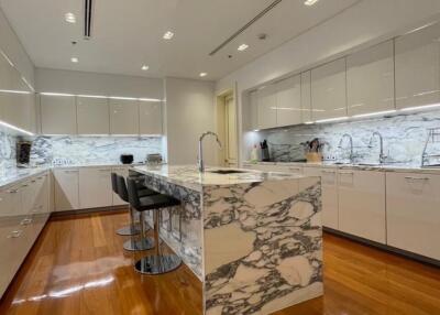 Modern kitchen with marble countertops and hardwood floors