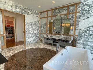 Spacious bathroom with dual vanity and white marble walls