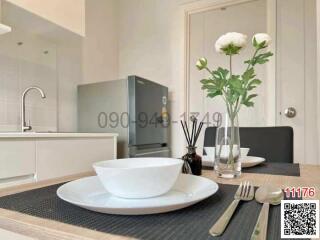 Modern kitchen with dining area showcasing elegant tableware and fresh flowers