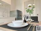 Modern kitchen with dining area showcasing elegant tableware and fresh flowers