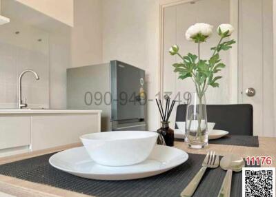 Modern kitchen with dining area showcasing elegant tableware and fresh flowers