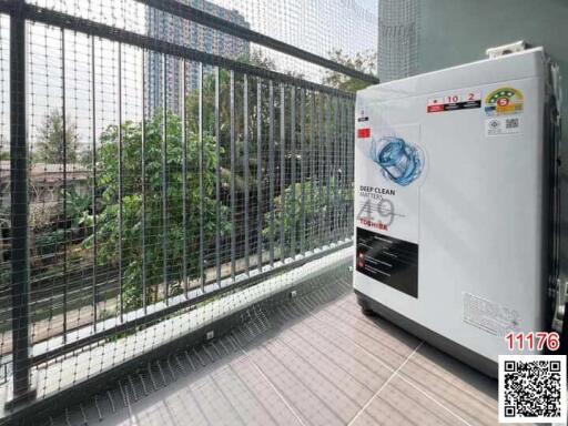 Apartment balcony with safety netting and outdoor washing machine