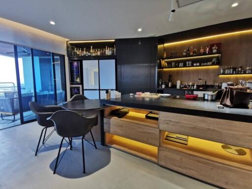 Modern kitchen with integrated lighting and bar-style seating