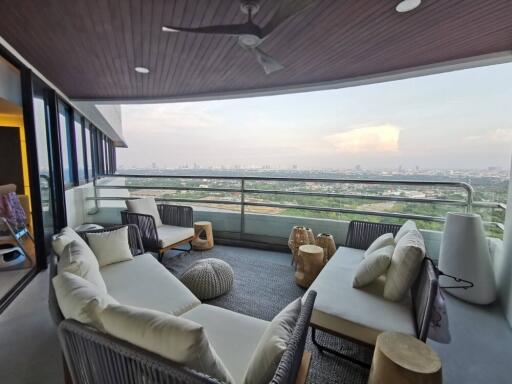 Spacious covered patio with comfortable seating and panoramic city views