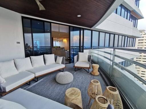 Modern balcony with city view, comfortable seating and ample lighting