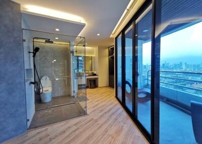 Modern bathroom with city view through large windows