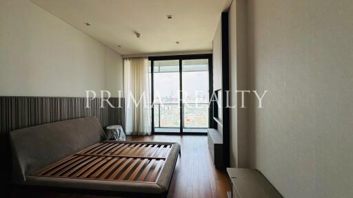 Modern bedroom with large windows and city view