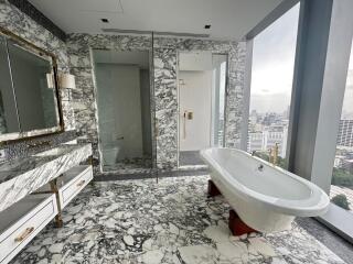 Luxurious bathroom with marble finish and freestanding bathtub