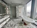 Luxurious bathroom with marble finish and freestanding bathtub