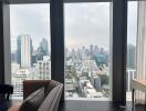 High-rise living room with expansive city view through floor-to-ceiling windows