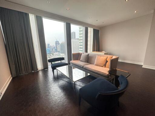 Modern living room with cityscape view through large windows