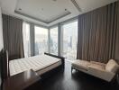 Spacious bedroom with city view and modern furniture