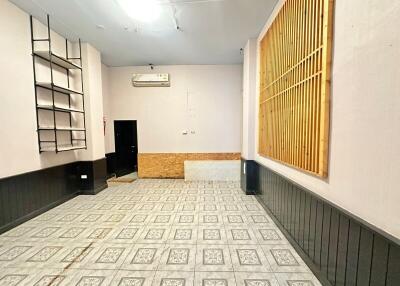 Spacious living room with tiled flooring and air conditioning unit