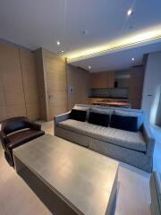 Modern living room with L-shaped sofa and recessed lighting