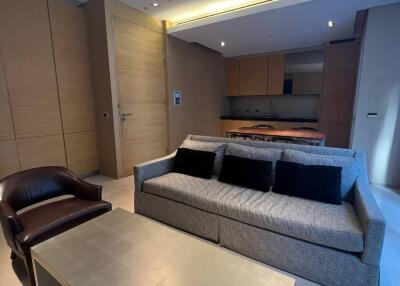 Modern living room with L-shaped sofa and recessed lighting