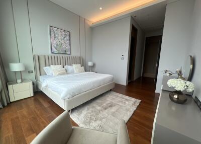 Elegant bedroom with modern decor, a large bed, and hardwood floors