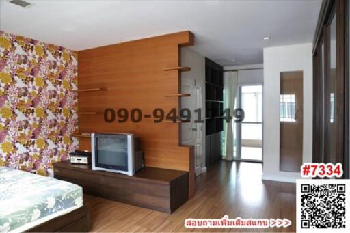 Cozy bedroom with wooden furniture and floral wallpaper