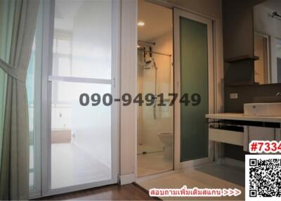 Compact apartment with sliding doors separating the bedroom, an en-suite bathroom, and a small kitchenette