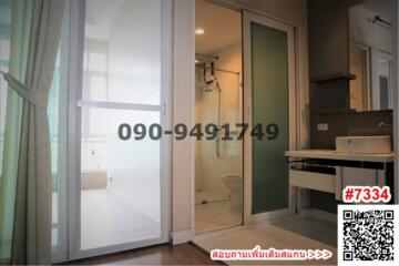 Compact apartment with sliding doors separating the bedroom, an en-suite bathroom, and a small kitchenette