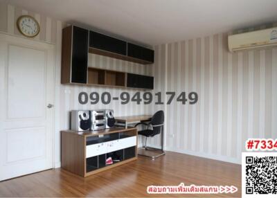 Modern furnished room with striped wallpaper and entertainment system