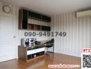 Modern furnished room with striped wallpaper and entertainment system