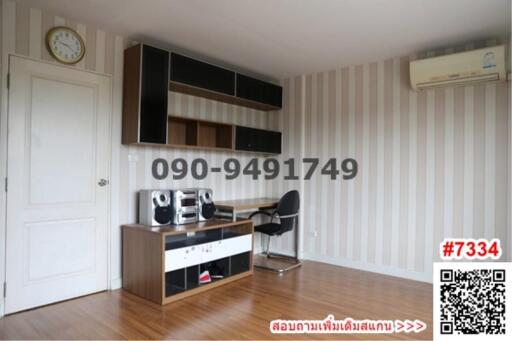 Modern furnished room with striped wallpaper and entertainment system