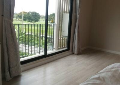 Cozy bedroom with a large window overlooking the garden