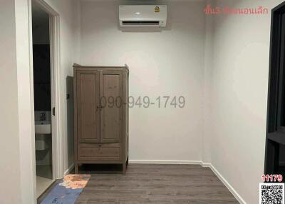 Modern bedroom with wooden wardrobe and air conditioning unit