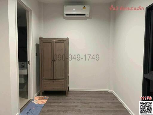 Modern bedroom with wooden wardrobe and air conditioning unit