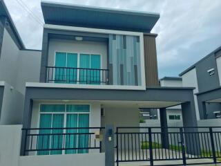 Modern two-story house with balcony and garage