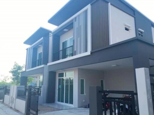 Modern two-story house with balconies and a secure entrance