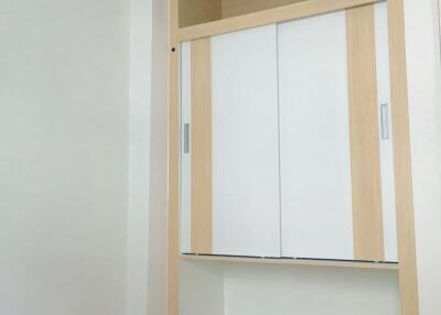 Minimalist bedroom with a large built-in wardrobe