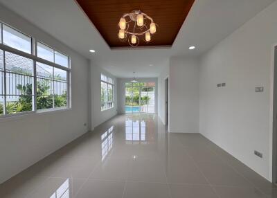 Spacious living room with large windows and modern lighting