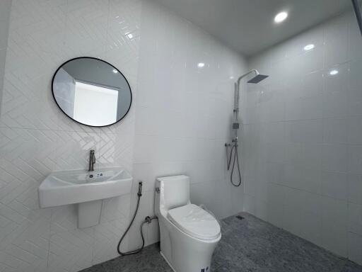 Modern bathroom with white tiles and sleek fixtures