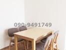Minimalist dining area with wooden table and chairs