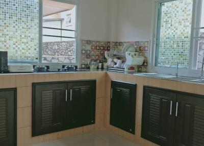 Modern kitchen with natural light and black cabinets