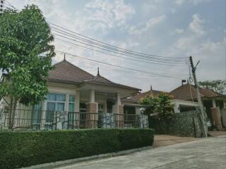 Spacious family house with tiled roof and stone fence