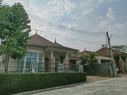 Spacious family house with tiled roof and stone fence