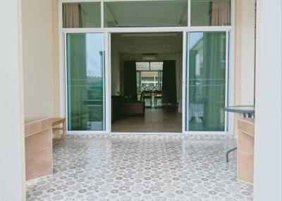 View into the home from the tiled patio with sliding glass doors