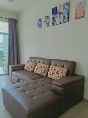 Cozy living room with brown leather sofa and decorative pillows