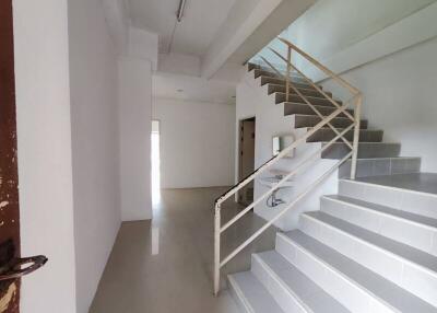 Empty interior space with staircase and open door