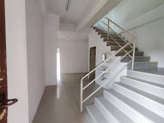 Empty interior space with staircase and open door