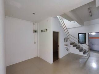 Spacious living area with staircase and bright interior