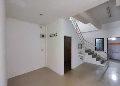 Spacious living area with staircase and bright interior